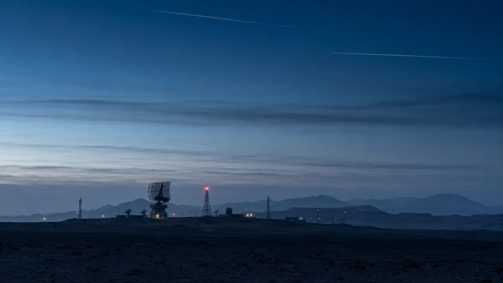 A distant radar installation at blue hour